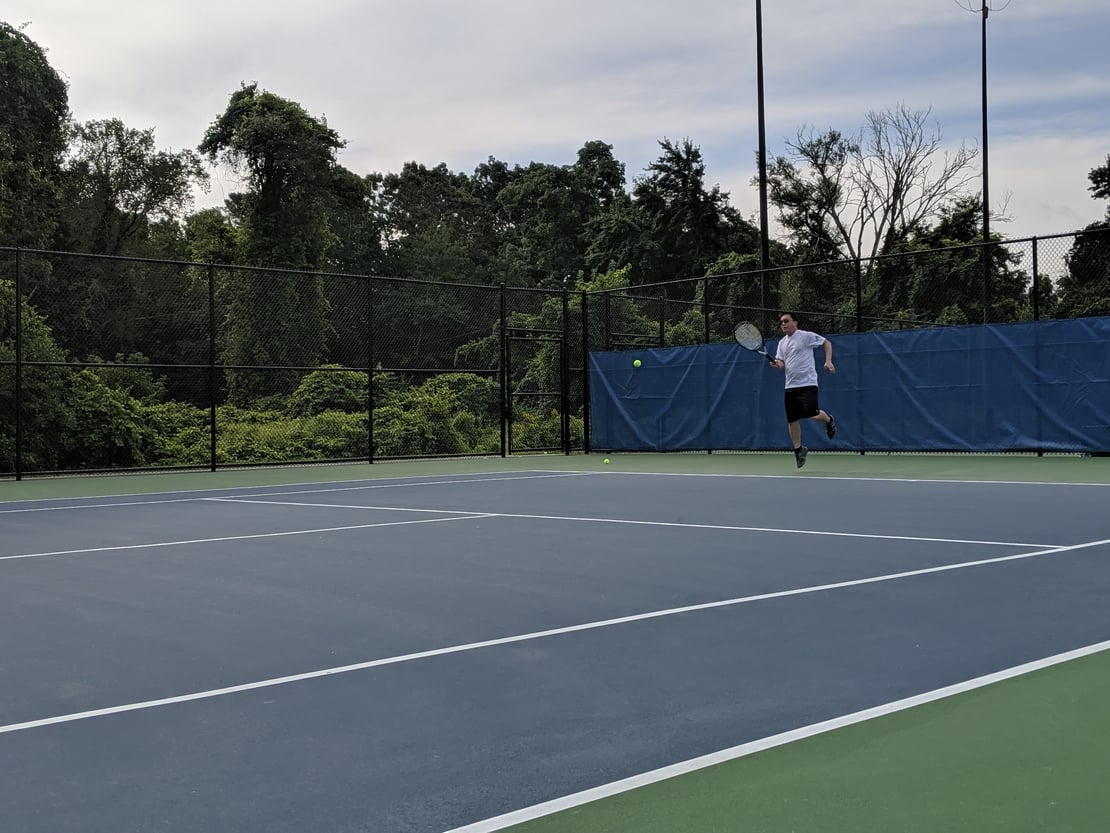 first round tennis player hitting a mario style forehand