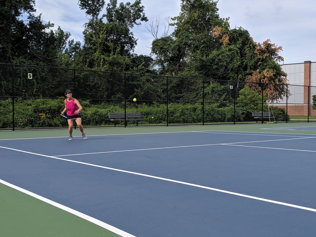 first round tennis player hitting a forehand